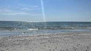 A beach with pebbles and a clear sky. - Spacious beach home - Sleeps 12 - Steps from dining, with a private heated pool (Marco Island)