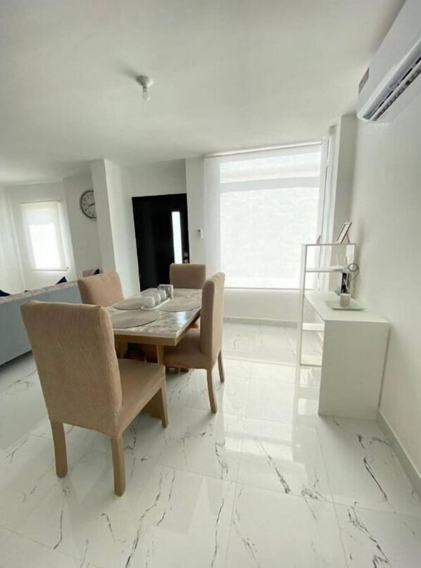 Enjoy meals in this stylish dining area with a large window and comfortable seating for four.
