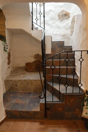 A staircase with a wrought iron railing and stone steps. - Spacious 4-Bed House (Algodonales)