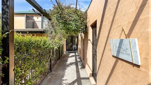 Stroll through the charming alleyway to our Mediterranean-style beach house.