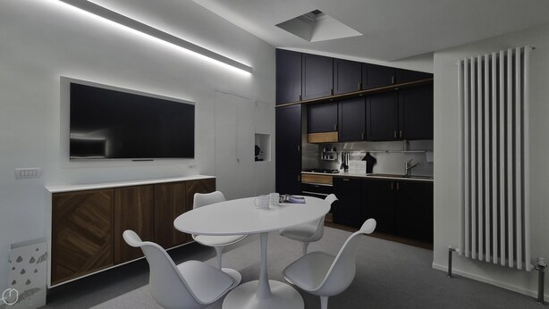 A modern kitchen with dark cabinets, a white countertop, and a built-in oven. - Italianway Comfort - Torino 48 (Milan)
