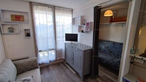 A modern living room with a grey sofa, a small cabinet, and a television. - Paradiski closed to the slopes vallandry (LANDRY)