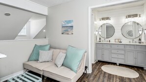 A modern bathroom with a vanity, two large mirrors, and a ceiling with a star design.