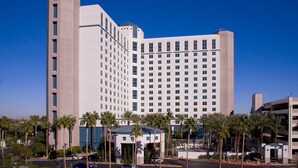 A large, multi-story hotel with a modern design, featuring a prominent corner tower and a central section with numerous windows. - Paradise, a Hilton Grand Vacations Club near the Las Vegas Convention Center (Las Vegas)