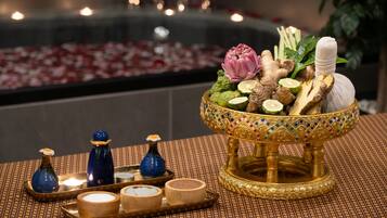 A decorative tray with a bowl of herbs and a candle holder.