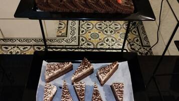 A table with three trays of desserts.