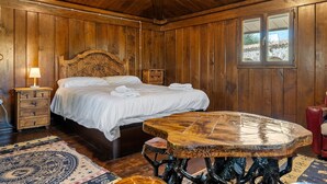 A wooden room with a bed, a table, and a window. - Holiday Home "Horrio" with Mountain View, Shared Pool & Wi-Fi (Querol)