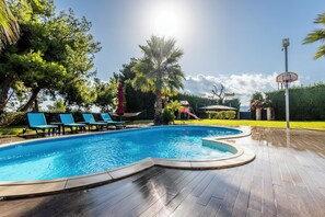 A swimming pool with lounge chairs and a palm tree. - Enjoy your vacation at a luxurious stone villa with garden & swimming pool! (Agioi Theodoroi)