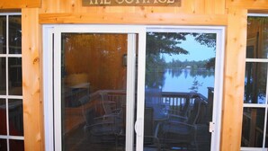 Entrada de una cabaña de madera con un letrero que dice 'THE COTTAGE'.