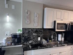 Fridge, microwave, stovetop, coffee/tea maker - Beachfront Escape you need, Relax in the adorable condo overlooking the ocean and pool. With a cute kitchenette, relaxing living area, smart TVs, and thoughtful touches throughout, it’s the perfect blend of comfort and relaxation. (Daytona Beach)