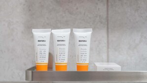 Three toiletries in a bathroom shelf.