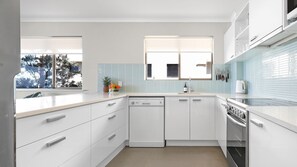 Enjoy cooking in this well-equipped kitchen with a dishwasher, stainless steel oven, and sink.
