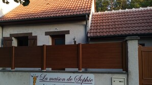A house with a sign indicating it is a vacation rental named "La maison de Sophie."