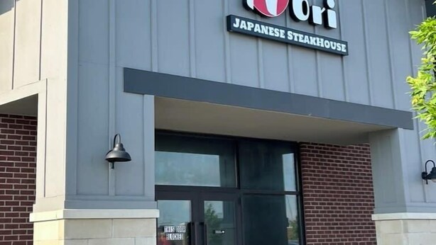 A Japanese steakhouse with a modern facade, a prominent logo, and a clear sign indicating its specialty.