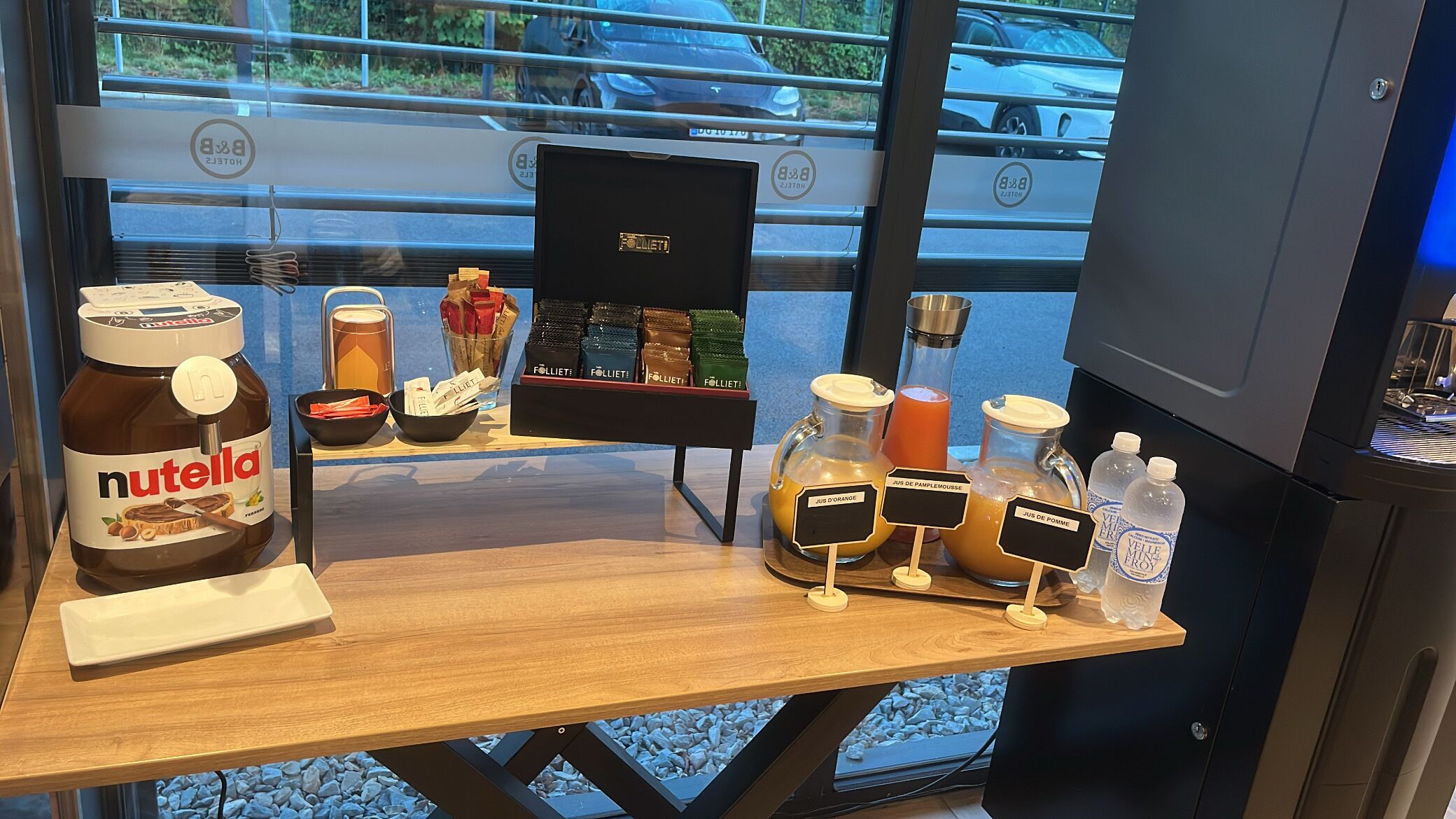A breakfast bar with Nutella, Folletier chocolates, and juice dispensers.