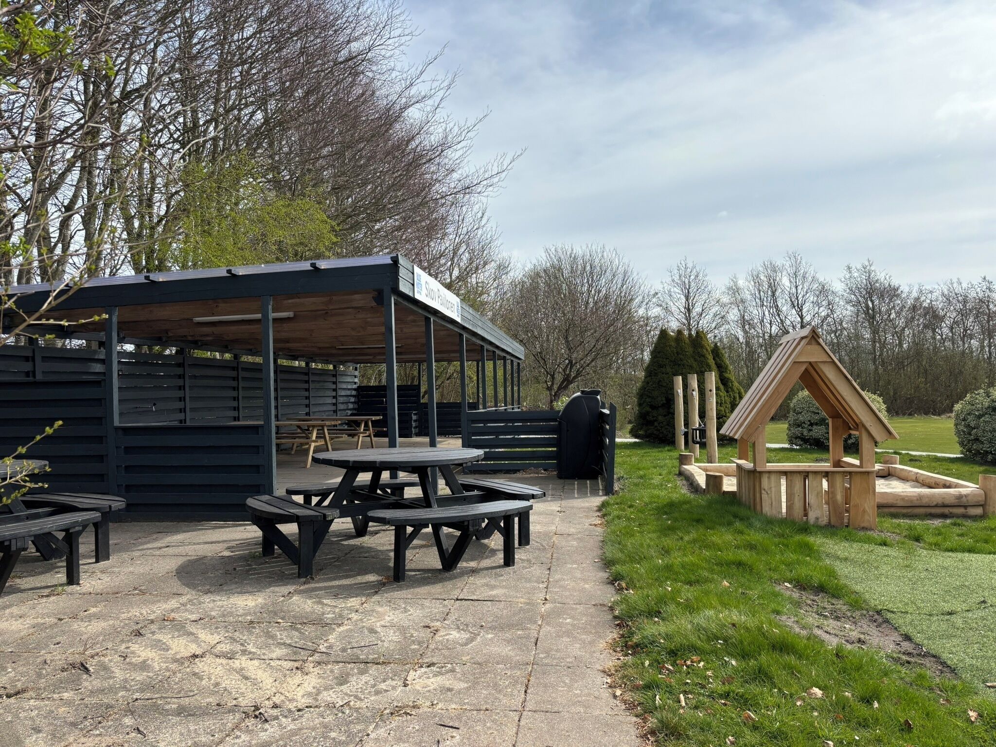 A picnic area with benches and a covered shelter.