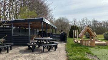 A picnic area with benches and a covered shelter.