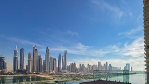 A high-rise building with a view of a city skyline and a body of water. - LUX  Luxury Sunrise Beachfront Suite 2 (Dubai)