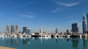 A marina with yachts docked and a skyline of modern buildings in the background. - LUX  Luxury Sunrise Beachfront Suite 2 (Dubai)