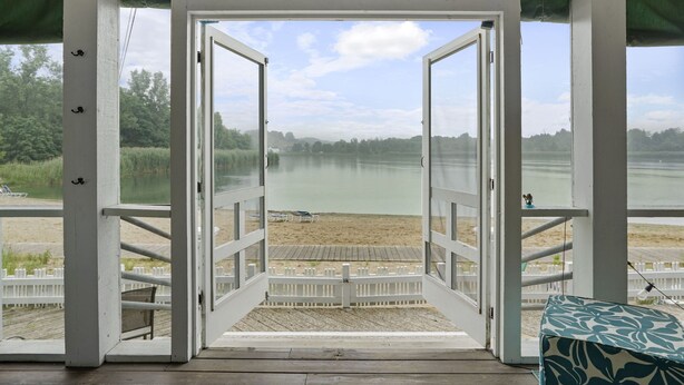 A beach view from a covered deck with a sign reading "Paradise Found".