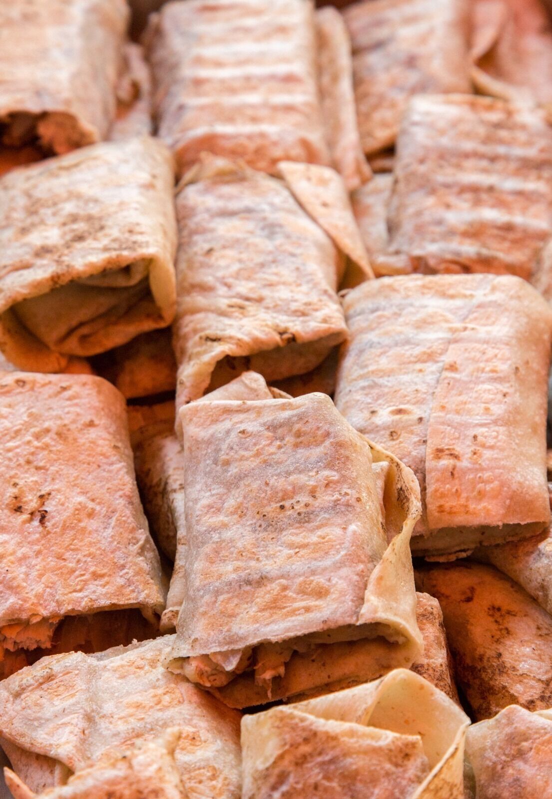 A close-up of rolled tortillas.
