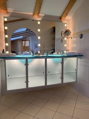 Enjoy a refreshing bathroom experience with a spacious vanity, two sinks, and a large mirror.