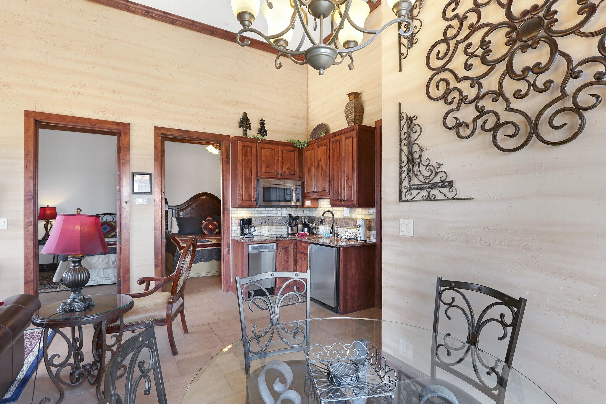 A compact living space with a kitchen, dining area, and a small seating area with a table and chairs.