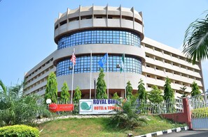 A hotel with a circular design, multiple floors, and a prominent sign for the Royal Bird Hotel & Tower. - Royal Birds Hotel & Towers (Akure)