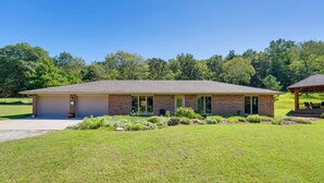 A single-story brick building with a flat roof, a covered porch, and a well-maintained lawn.