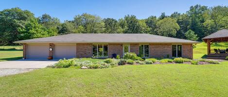 A single-story brick building with a flat roof, a covered porch, and a well-maintained lawn.