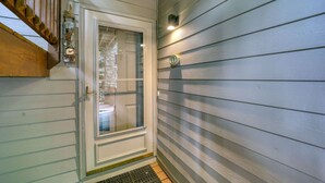 Eine Tür mit Fensterteil, ein Briefkasten und eine kleine Wandleuchte.