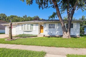 A single-story house with a front porch, a garage, and a well-maintained lawn. - Pet-friendly Waterloo Abode w/ Deck! (Waterloo)