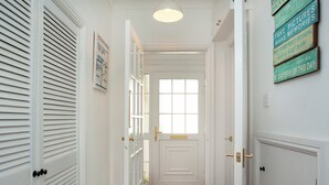 A hallway with white doors, a window, and a rug. - 3 bedroom accommodation in Hope Cove, near Kingsbridge (Hope Cove, near Kingsbridge)