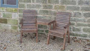 Two wooden chairs against a stone wall with a sign reading "Little Pythorn". - Little Pythorn - UK45253 (Westerdale, near Castleton)