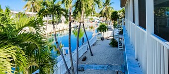 Radiant waterfront retreat with remarkable views, patio, tennis court, & grill