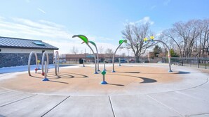An outdoor basketball court with hoops and a clear sky.