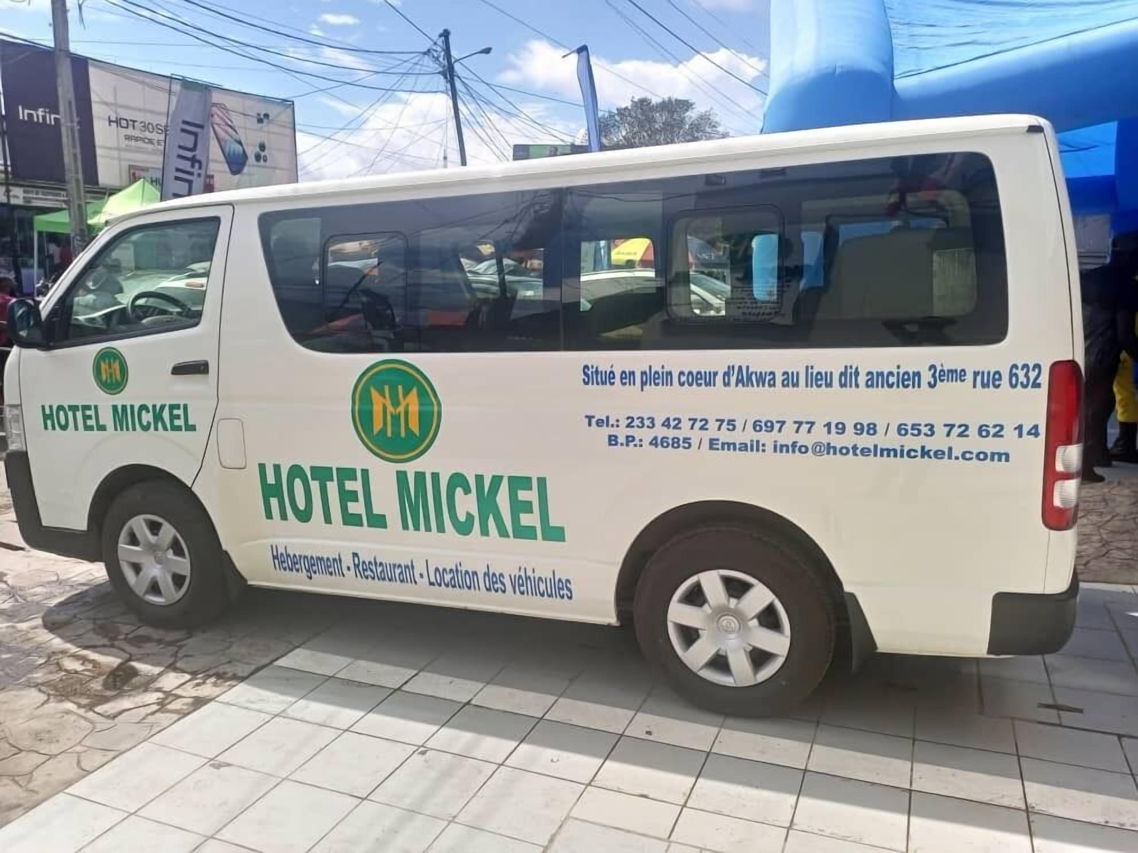 A white van with the text "HOTEL MICKEL" and contact information.