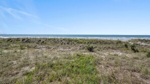 A coastal landscape with a beach and dunes. - Beachmaster 104-2BR Oceanfront Condo (North Myrtle Beach)