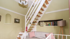 A staircase with white railings and wooden steps leading to a landing. - Hapton Folly (Waterlooville)