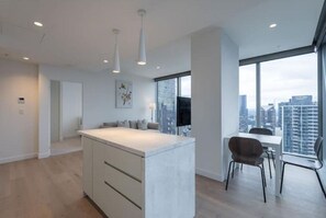 Enjoy meals and gatherings in this stylish space with a central island counter and modern dining area.