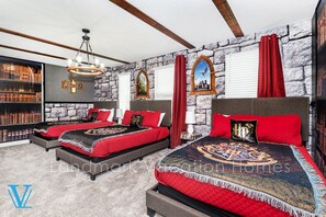 A bedroom with two beds, a stone wall, a bookshelf, and a chandelier. - Special Offer! Walk to Target, Private pool and SPA, Storey Lake 4549 (Kissimmee)