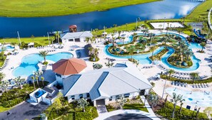A resort with multiple swimming pools, a large central building, and a view of a lake. - Special Offer! Walk to Target, Private pool and SPA, Storey Lake 4549 (Kissimmee)