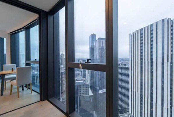 Enjoy a panoramic city view from the large window in this stylish room with a simple layout and comfortable seating area.