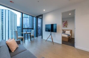 Enjoy a city view from the large window, relax on the comfortable sofa, and unwind in the neatly made bed.