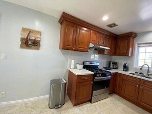 Enjoy cooking in this well-equipped kitchen with an oven and range hood.
