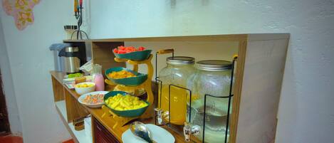 A buffet setup with various food items and beverages.