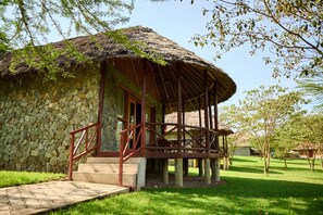 A stone building with a thatched roof and wooden balcony. - PELICAN LODGE - LAKE ELEMENTAITA (Gilgil)