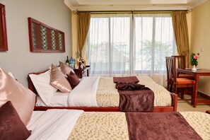 A hotel room with two beds, a desk, and a chair. - PELICAN LODGE - LAKE ELEMENTAITA (Gilgil)