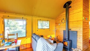 A cozy cabin interior with a sofa, dining table, and a wood-burning stove. - The Owls Hollow - UK45297 (Bishop Thornton, near Harrogate)