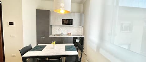 Comfort Apartment | Private kitchen | Full-size fridge, microwave, oven, stovetop